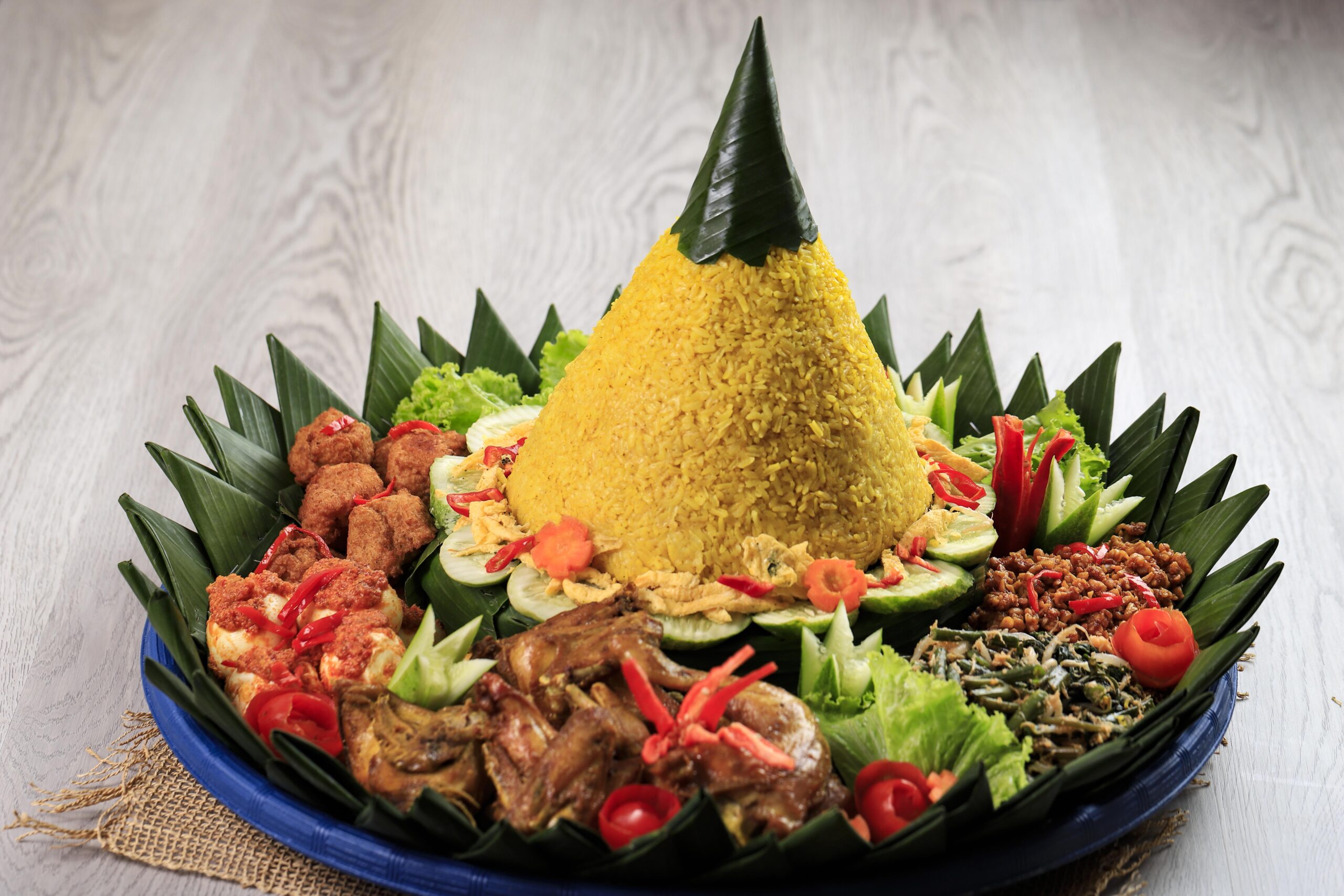 yellow-rice-cone-shape-indonesia-called-nasi-tumpeng-festive-indonesian-rice-dish-with-side-dishes nasi tumpang